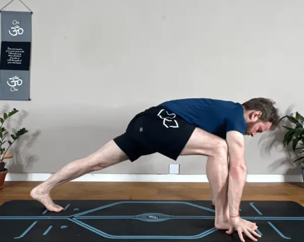 Begin in Downward Facing Dog. Focus on grounding your hands and spreading your fingers to distribute your weight evenly. Breathe steadily, preparing your mind and body for the transition. Step to the top of the mat for Low Lunge